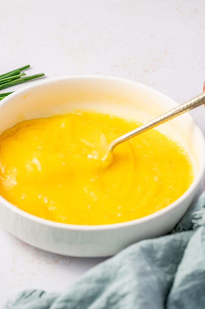Whisking eggs in a white bowl.