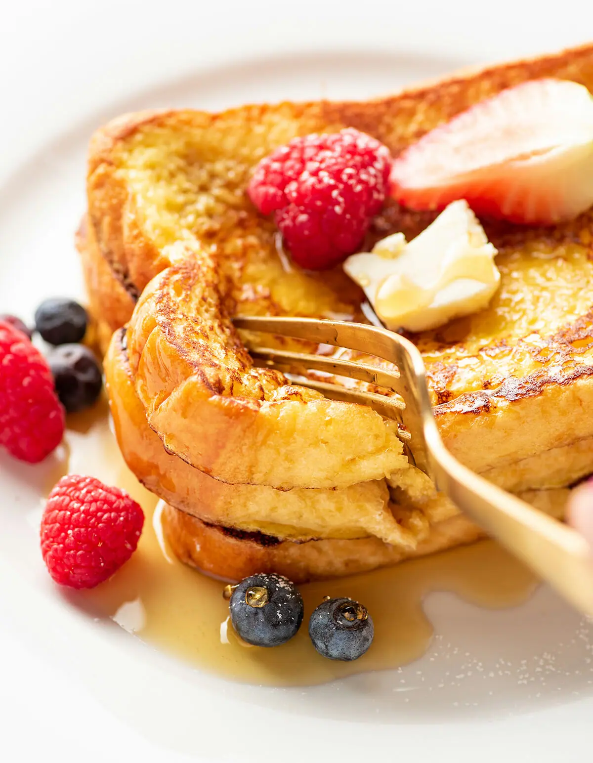 Homemade easy French toast topped with maple syrup and berries