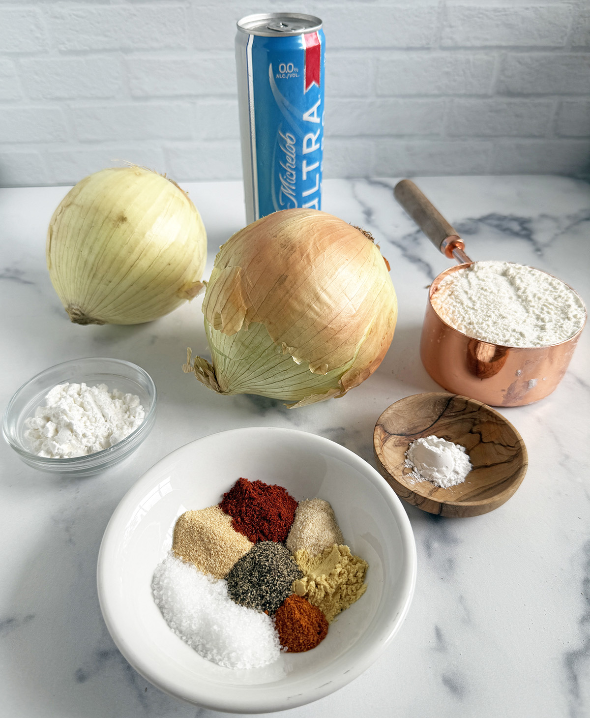 All the ingredients needed to make beer battered onion rings.