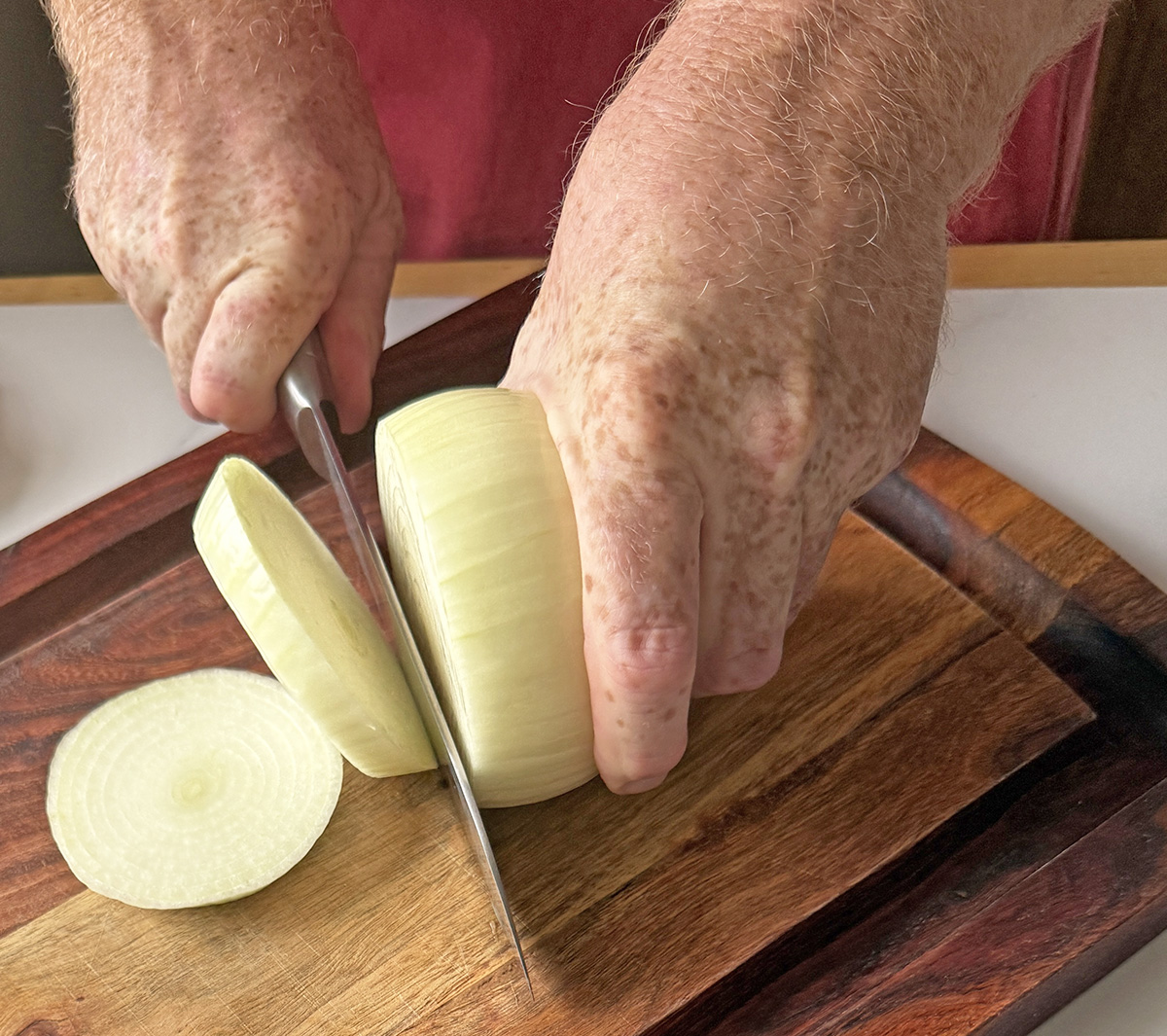 Slicing onions to make beer battered onion rings.