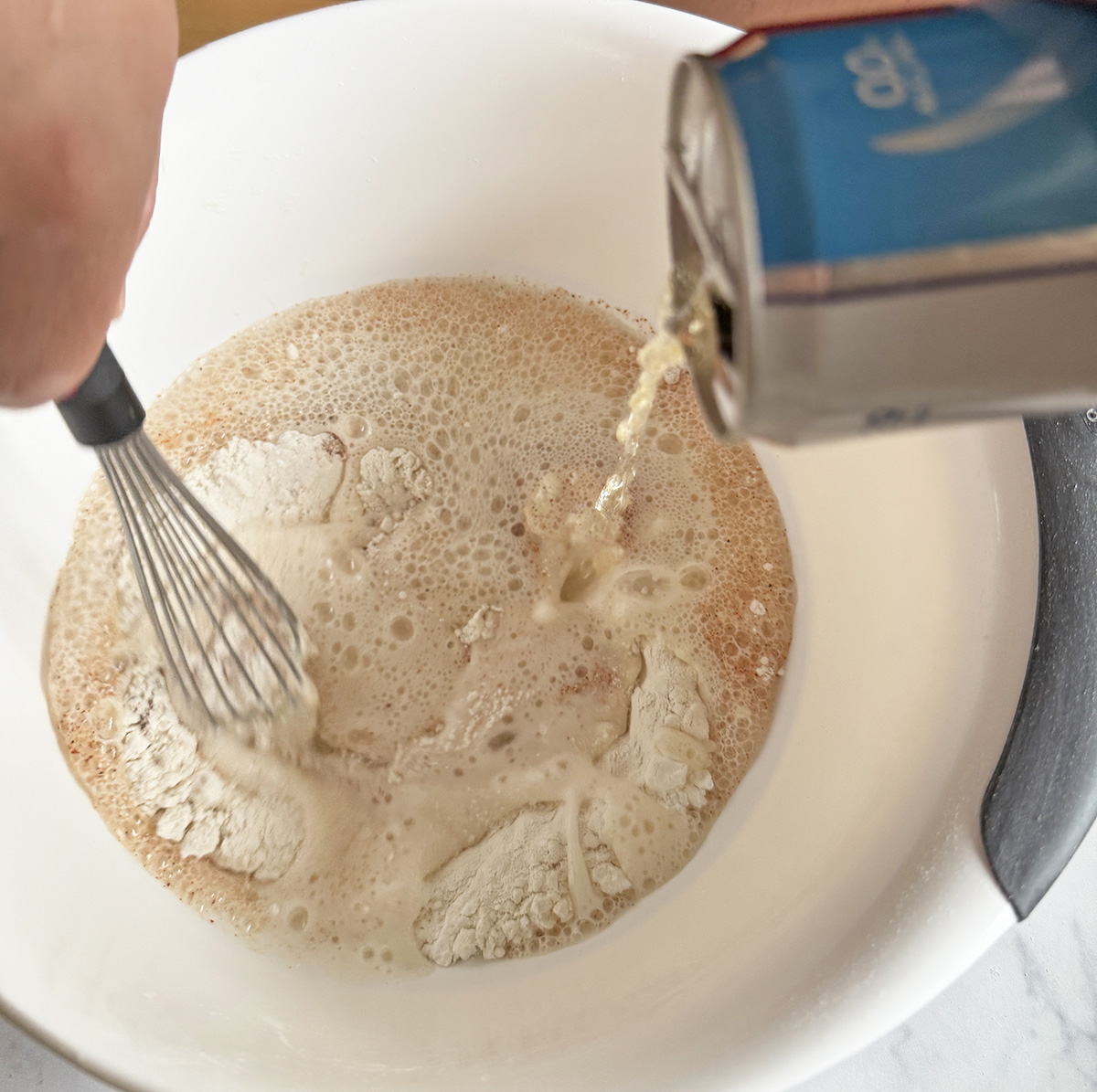 Making the batter for beer-battered onion rings.