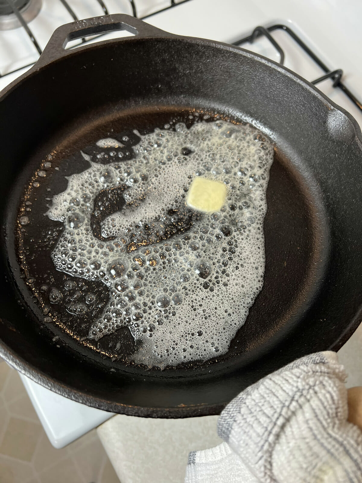 Adding butter to skillet to make cornbread