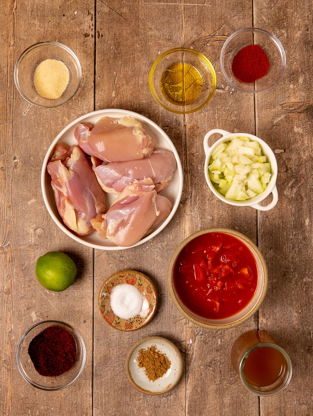Ingredients for Instant Pot chicken tacos on a rustic wooden surface.