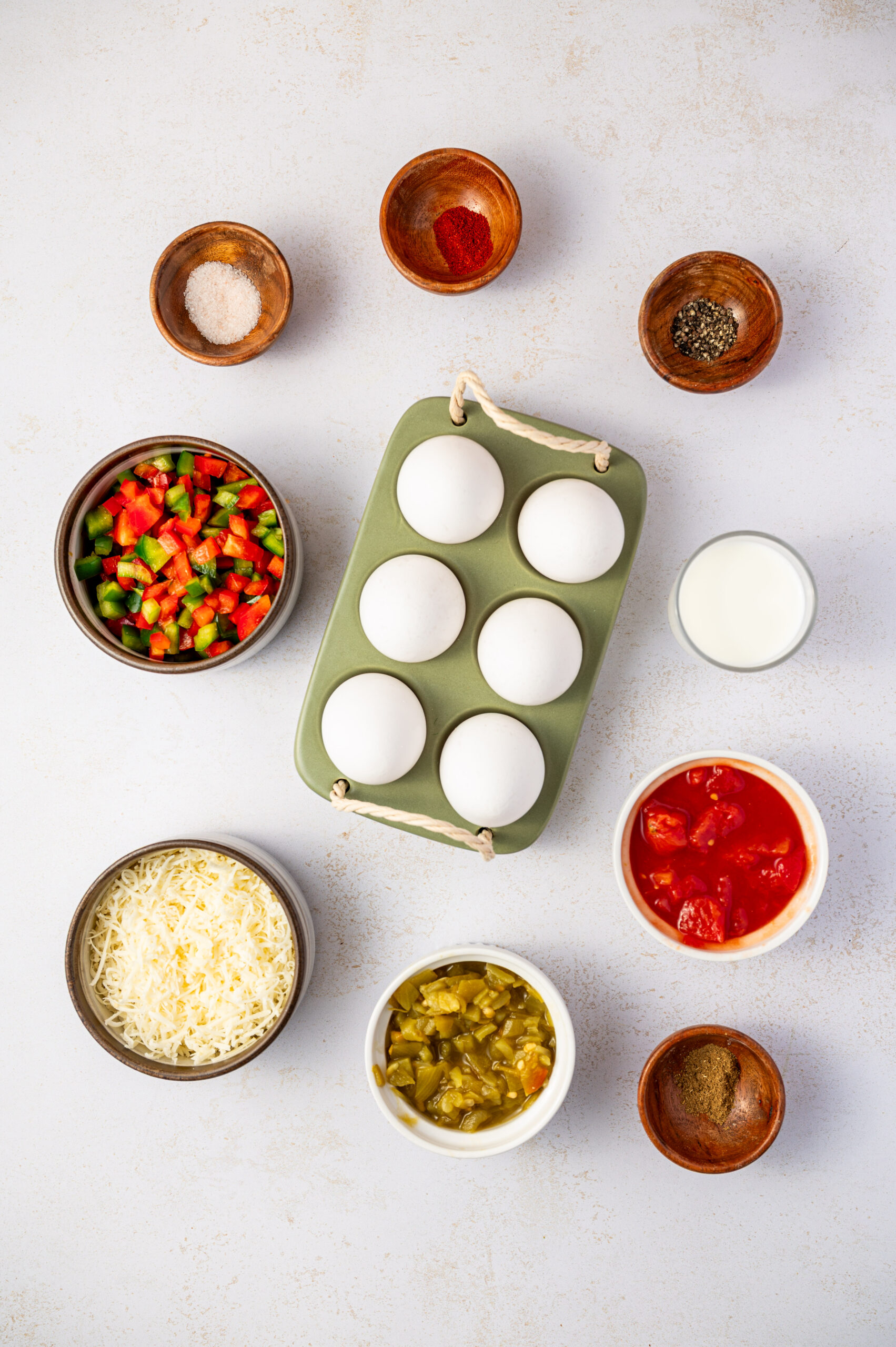 Ingredients for Southwestern scrambled egg bites on a white counter top.