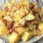 Parmesan ranch potatoes made in an Instant Pot, served on a plate with fresh parsley.
