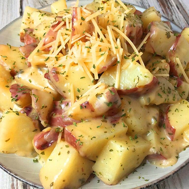Parmesan ranch potatoes made in an Instant Pot, served on a plate with fresh parsley.