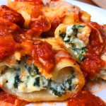 Stuffed shells with ricotta cheese and spinach served with tomato sauce