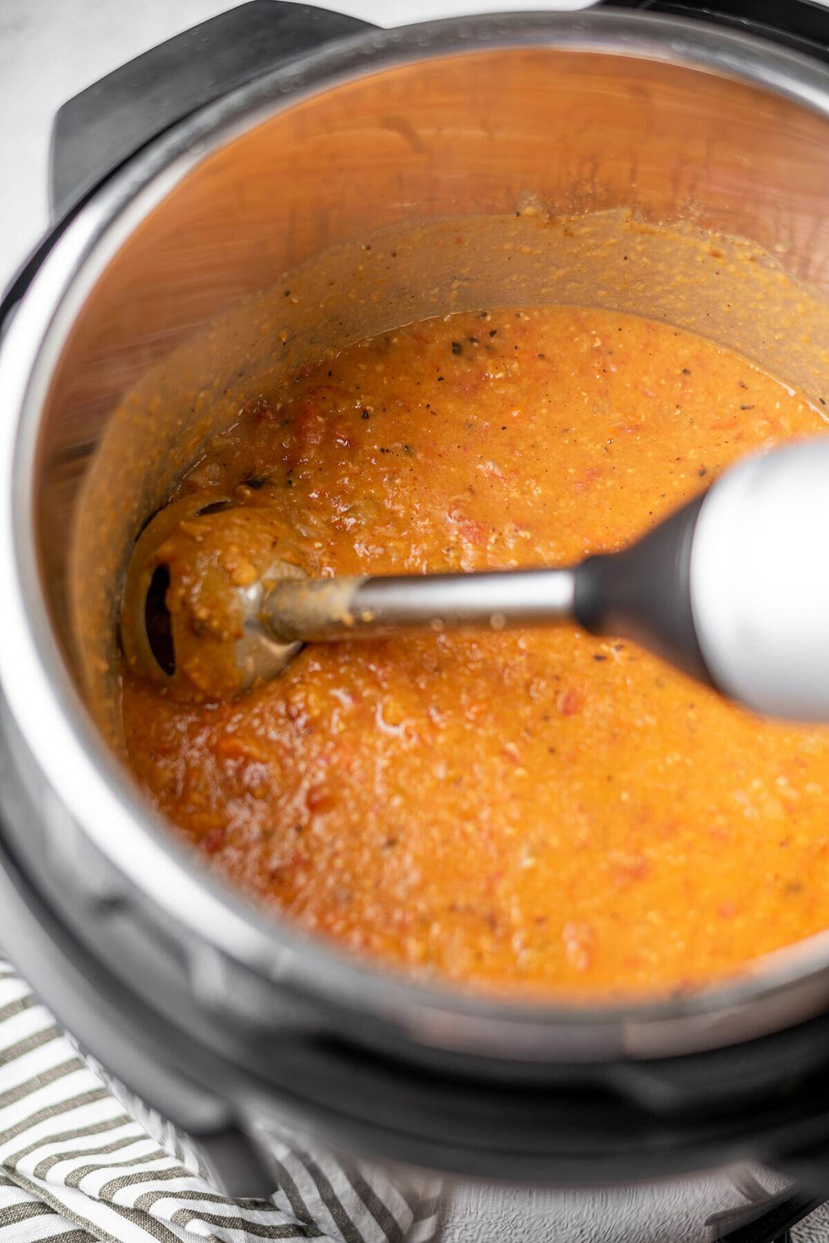Blending red lentil soup with an immersion blender