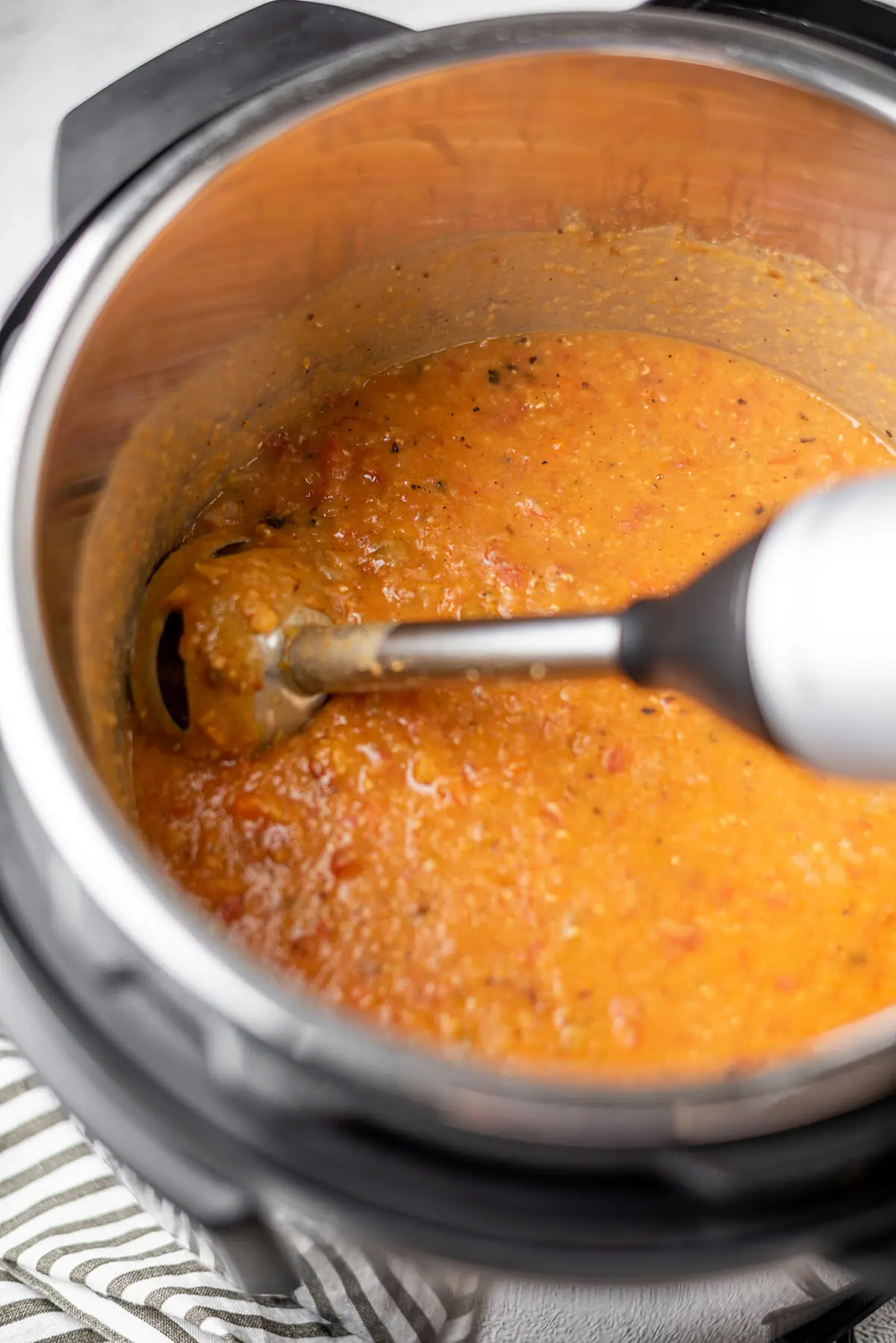 Blending red lentil soup with an immersion blender