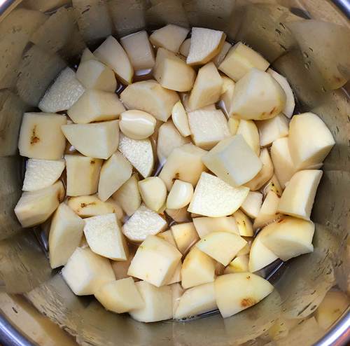 Russet potatoes cut into 1 inch chunks ready to me pressure cooked.