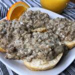 A plate of biscuits and gravy with homemade sausage gravy from an Instant Pot electric pressure cooker.