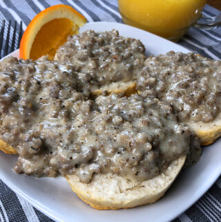 A plate of biscuits and gravy with homemade sausage gravy from an Instant Pot electric pressure cooker.
