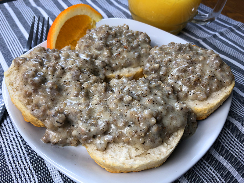A plate of biscuits and gravy with homemade sausage gravy from an Instant Pot electric pressure cooker.
