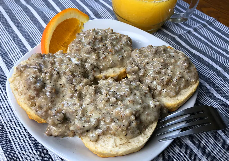 A plate of biscuits and homemade Instant Pot sausage gravy.