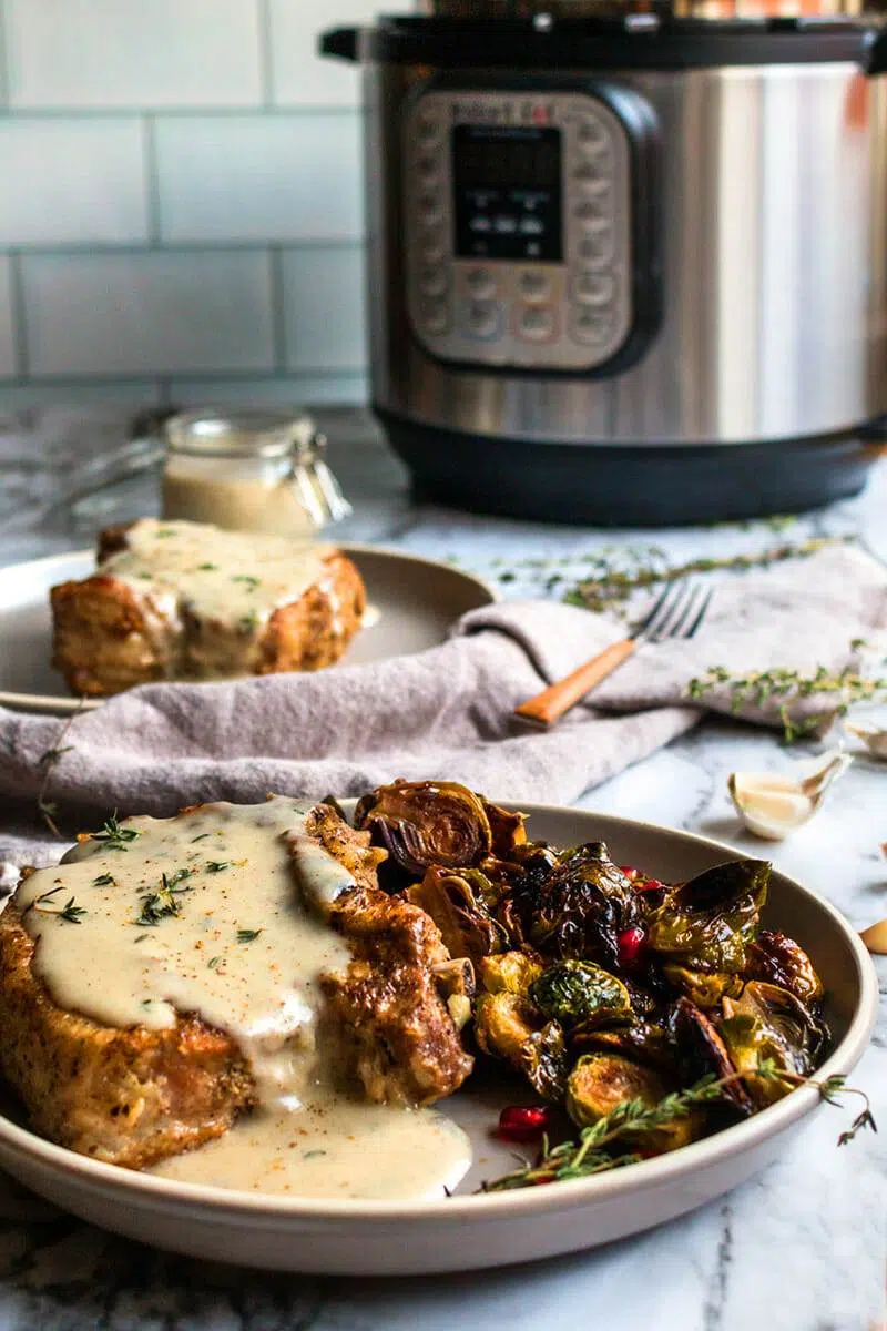 Smothered creamy garlic pork chops recipe made in an Instant Pot