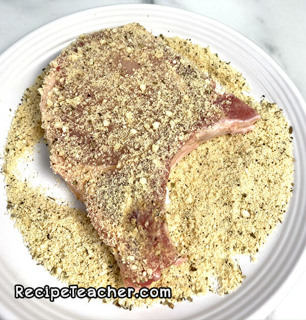 Adding seasonings to pork chops for air fryer parmesn ranch pork chops recipe.