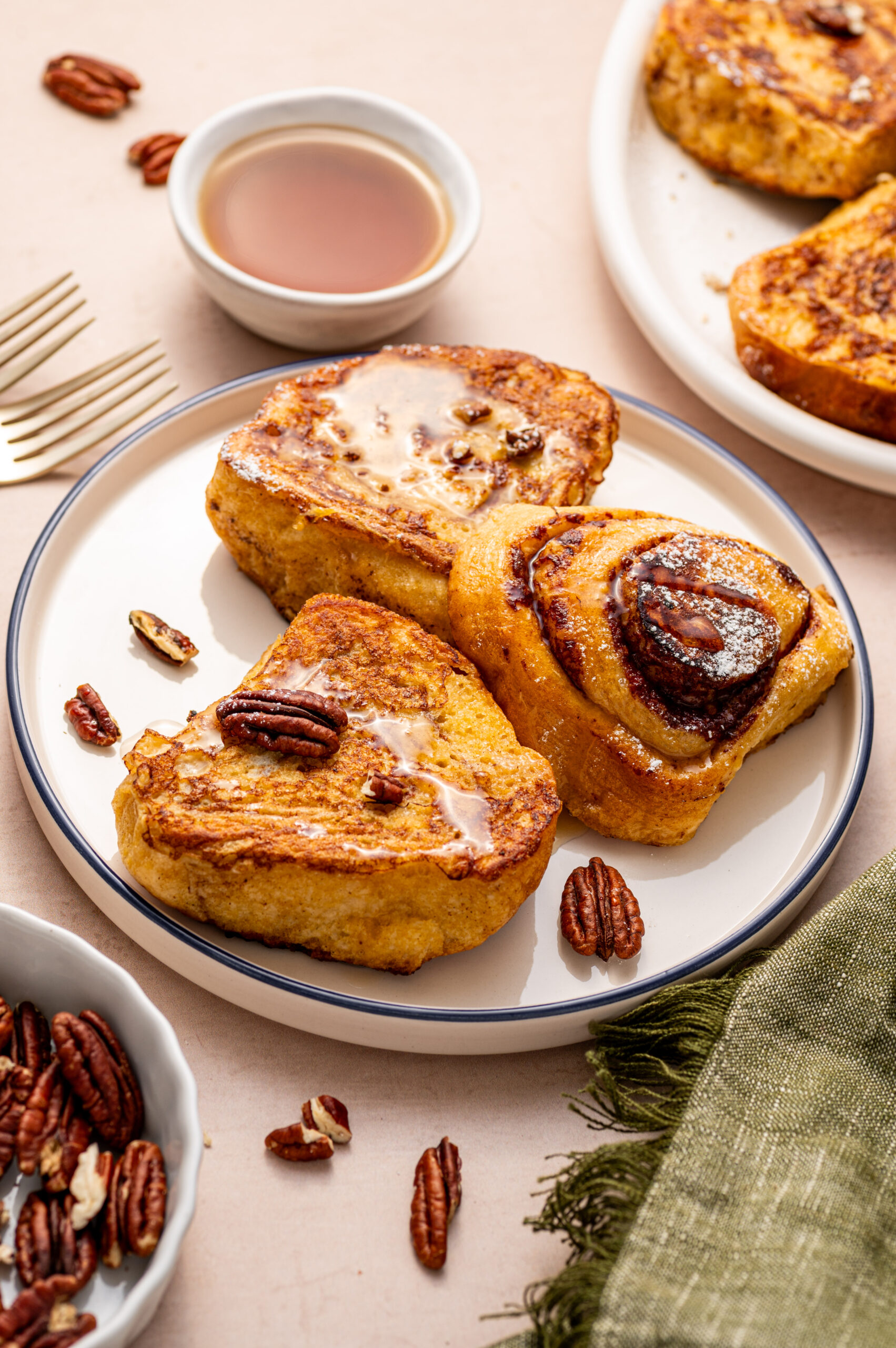 Cinnamon roll French toast with glaze and pecans.