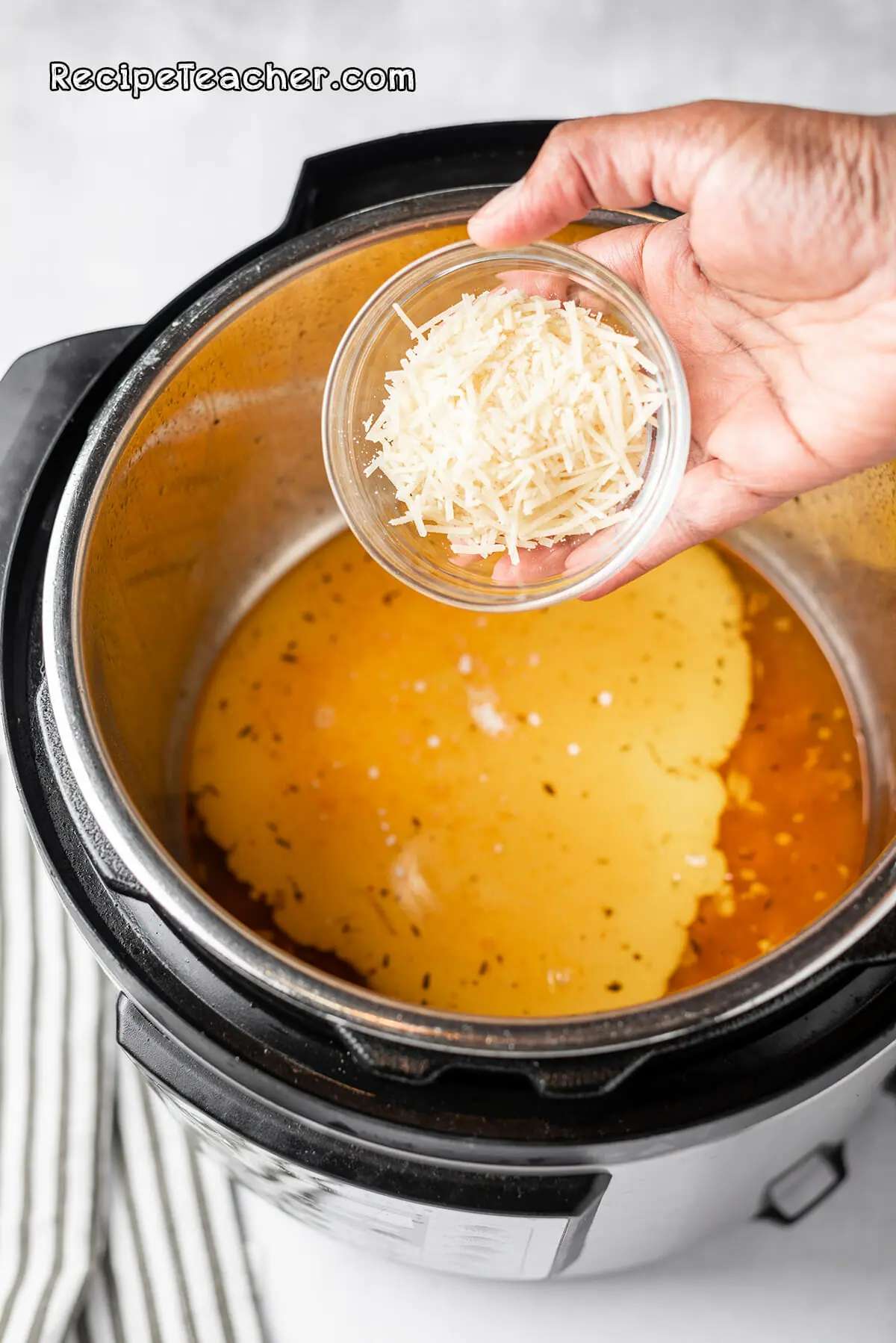 Cooking chicken thighs in an Instant Pot pressure cooker for our creamy garlic chicken thighs recipe.