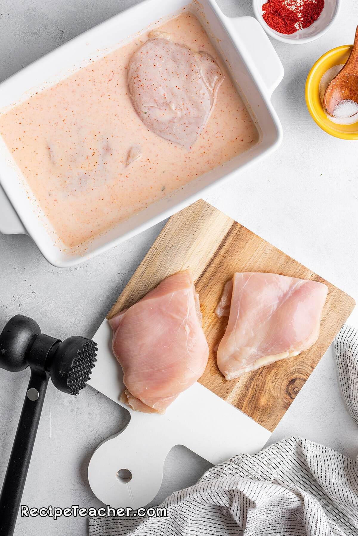 Preparing the chicken for our air fryer buttermilk spicy chicken sandwich recipe.