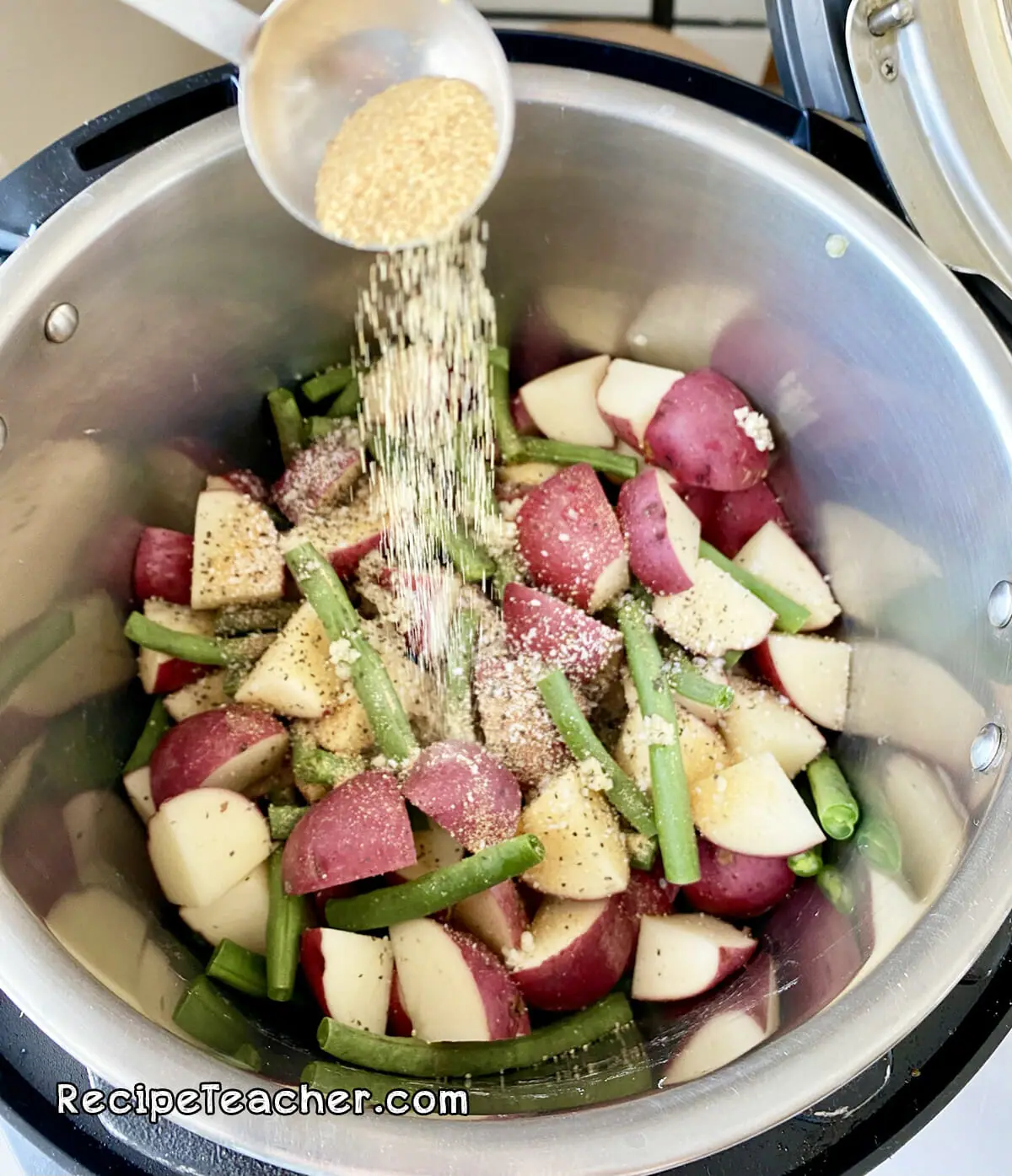 Recipe for Instant Pot potatoes and green beans with a creamy Parmesan garlic sauce.
