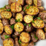 Simply irresistible air fryer roasted potatoes seasoned with garlic and herbs.