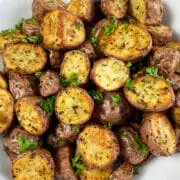 Simply irresistible air fryer roasted potatoes seasoned with garlic and herbs.