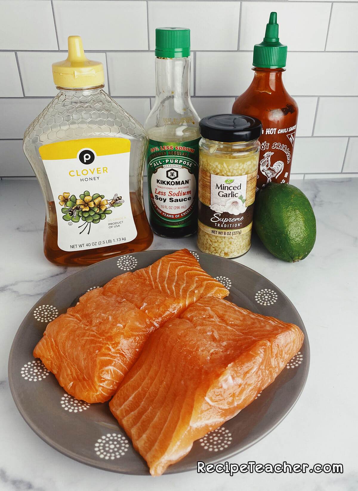Ingredients for Asian air fryer salmon on a kitchen counter over a marble surface.