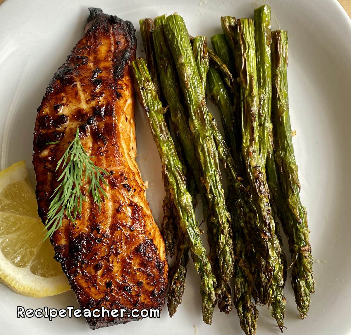 Air fryer citrus garlic salmon served with asparagus.