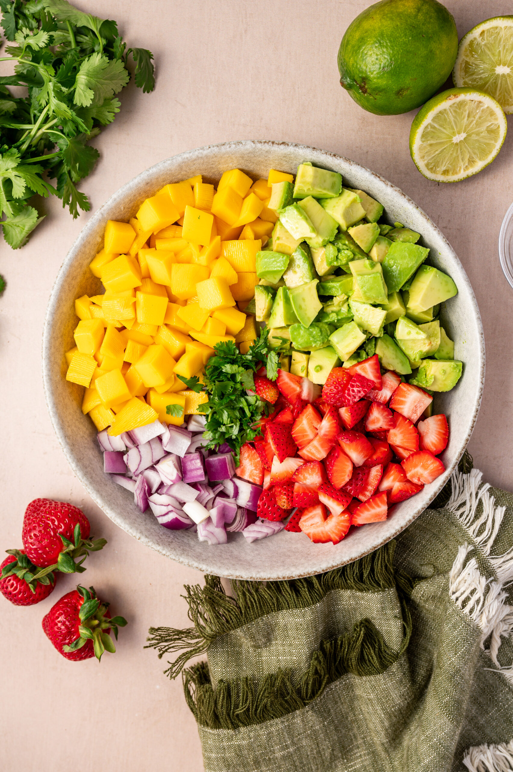 Salsa ingredients in a white bowl before getting mixed.