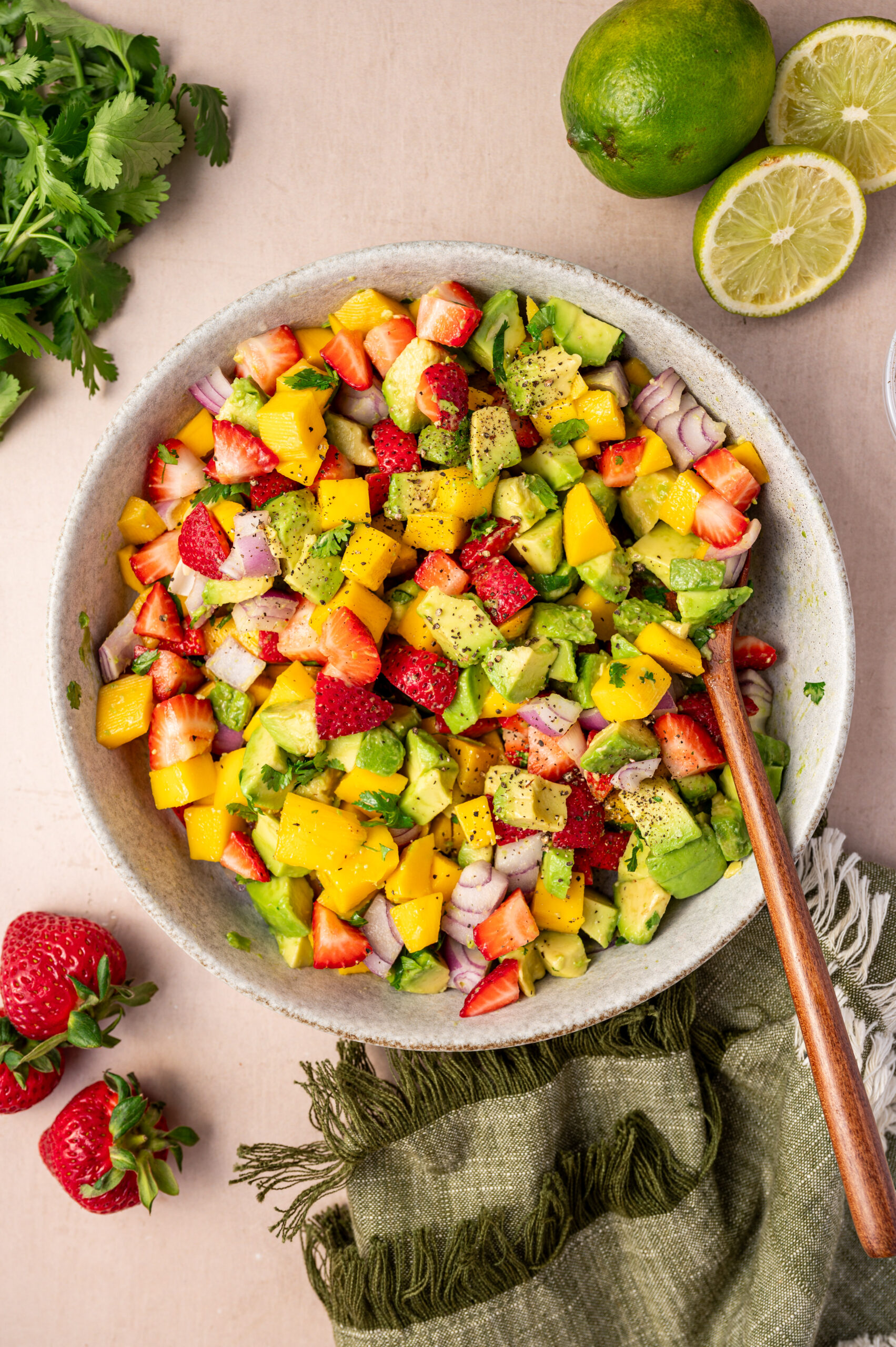Mixing the salsa ingredients together in a white bowl.