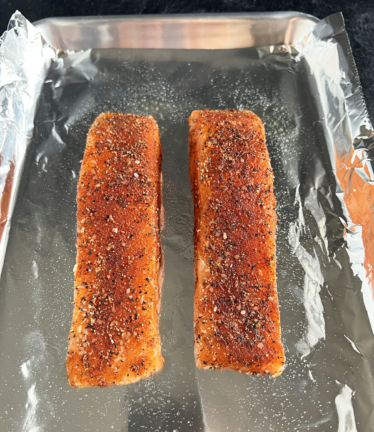 Seasoned salmon filets ready to go in the oven.