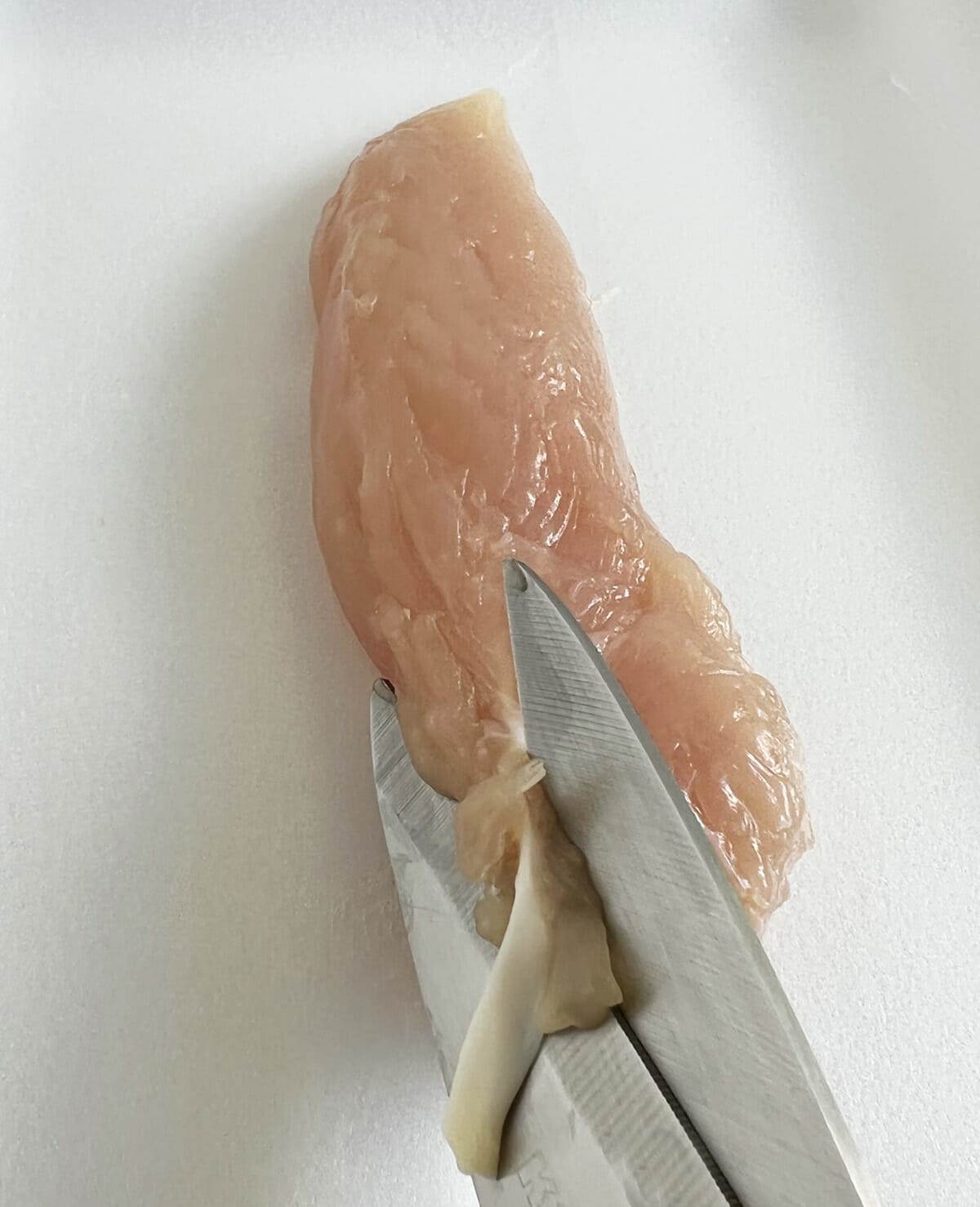 Cutting or removing the tendon from chicken breast tenderloins