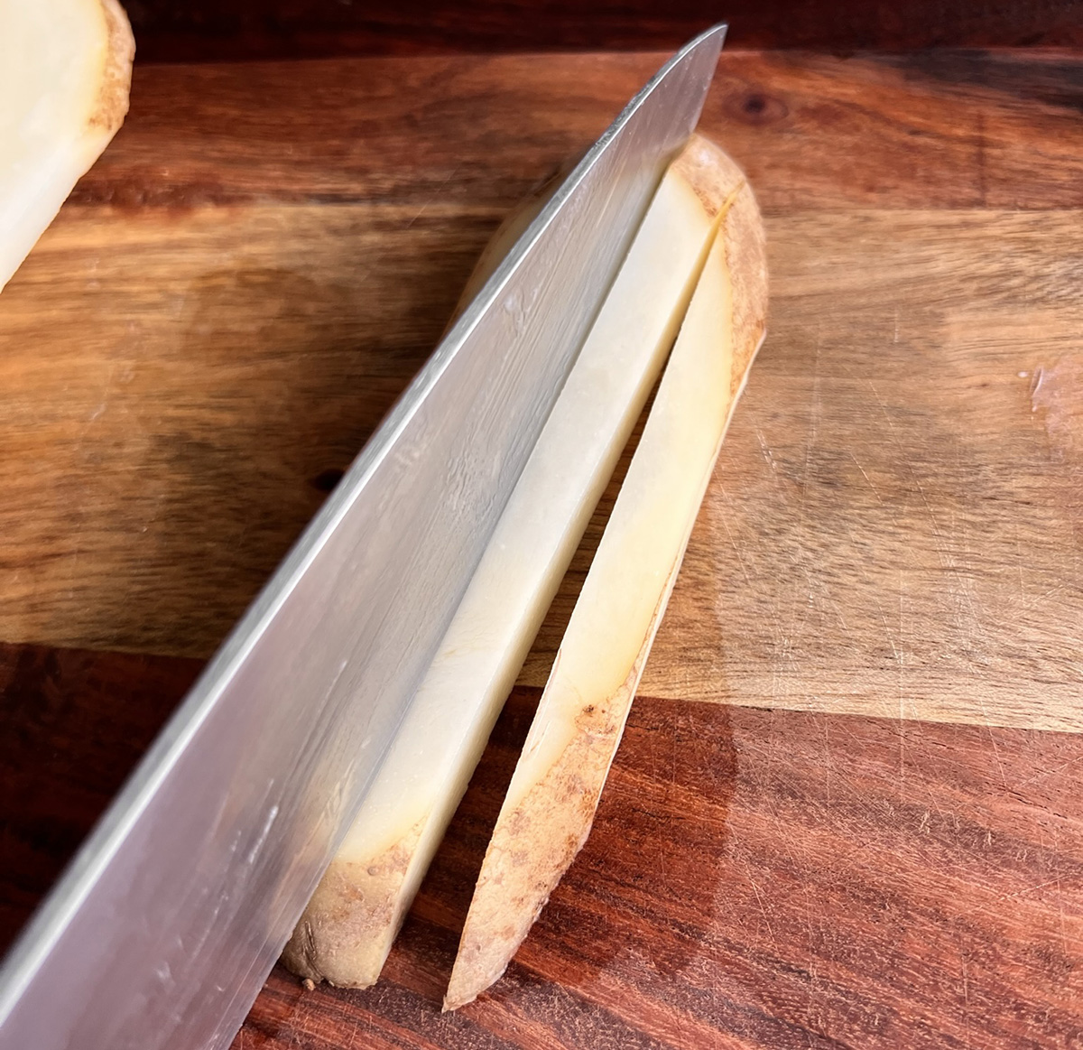 Slicing potatoes to make air fryer homestyle fries.