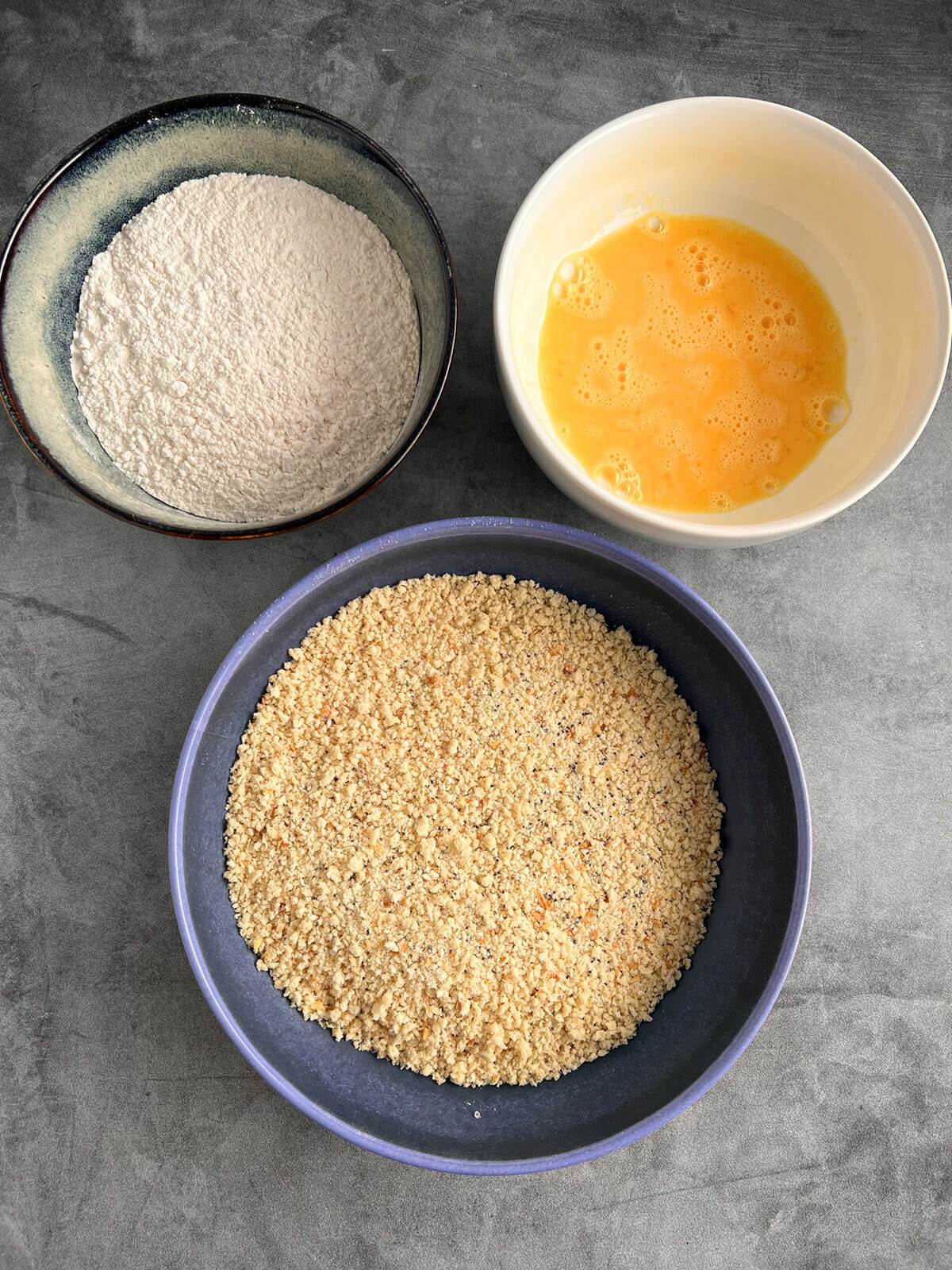 Setting up a breading station for making fried cauliflower.