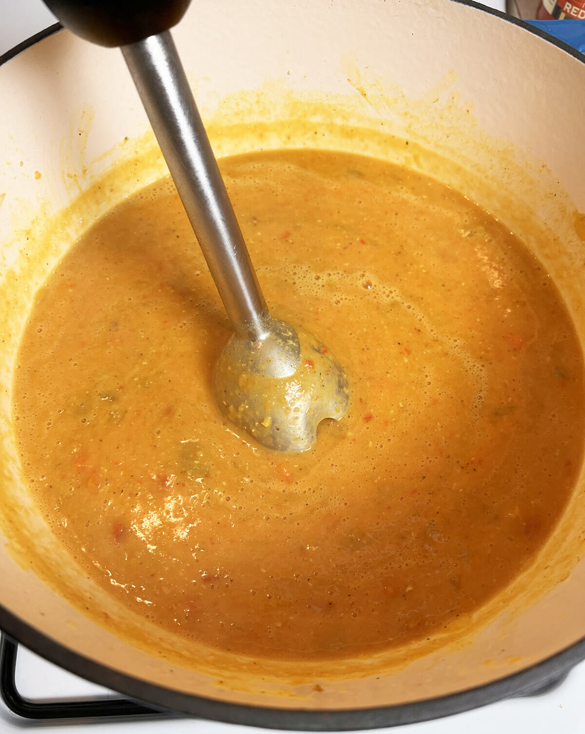 Using an immersion blender while making red lentil soup.