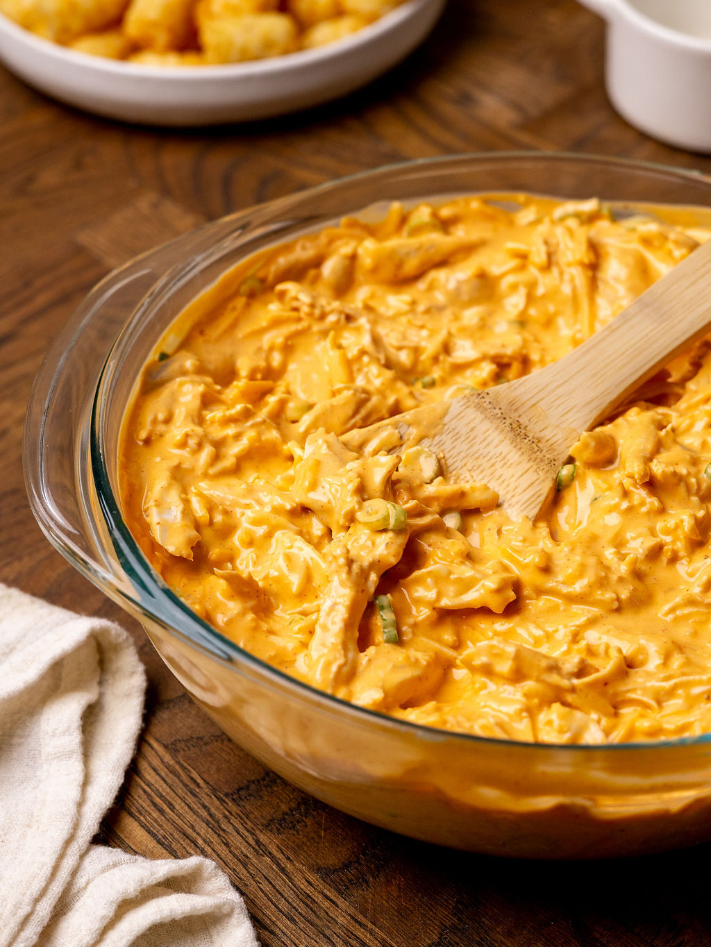 Buffalo chicken filling in a glass mixing bowl.