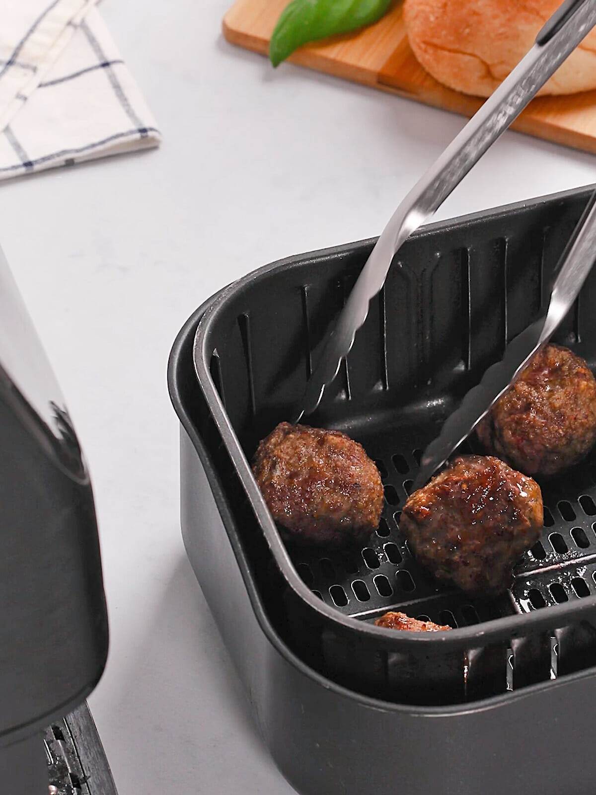 Cooking meatballs in your air fryer for delicious meatball sandwiches.