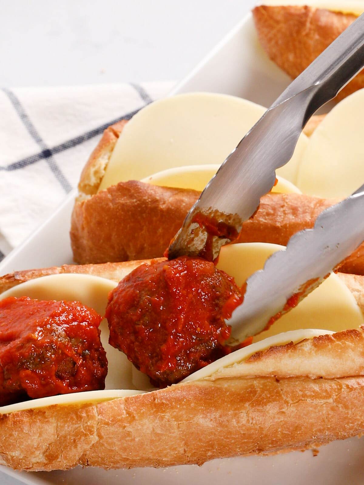 Assembling a meatball sandwich with homemade air fryer meatballs.