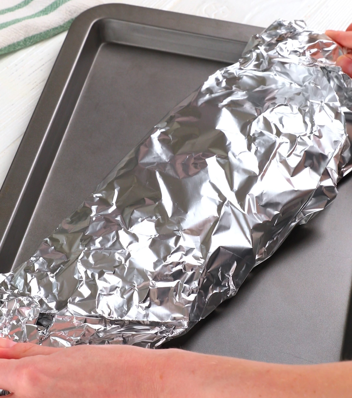 Wrapping ribs in foil to make in oven.