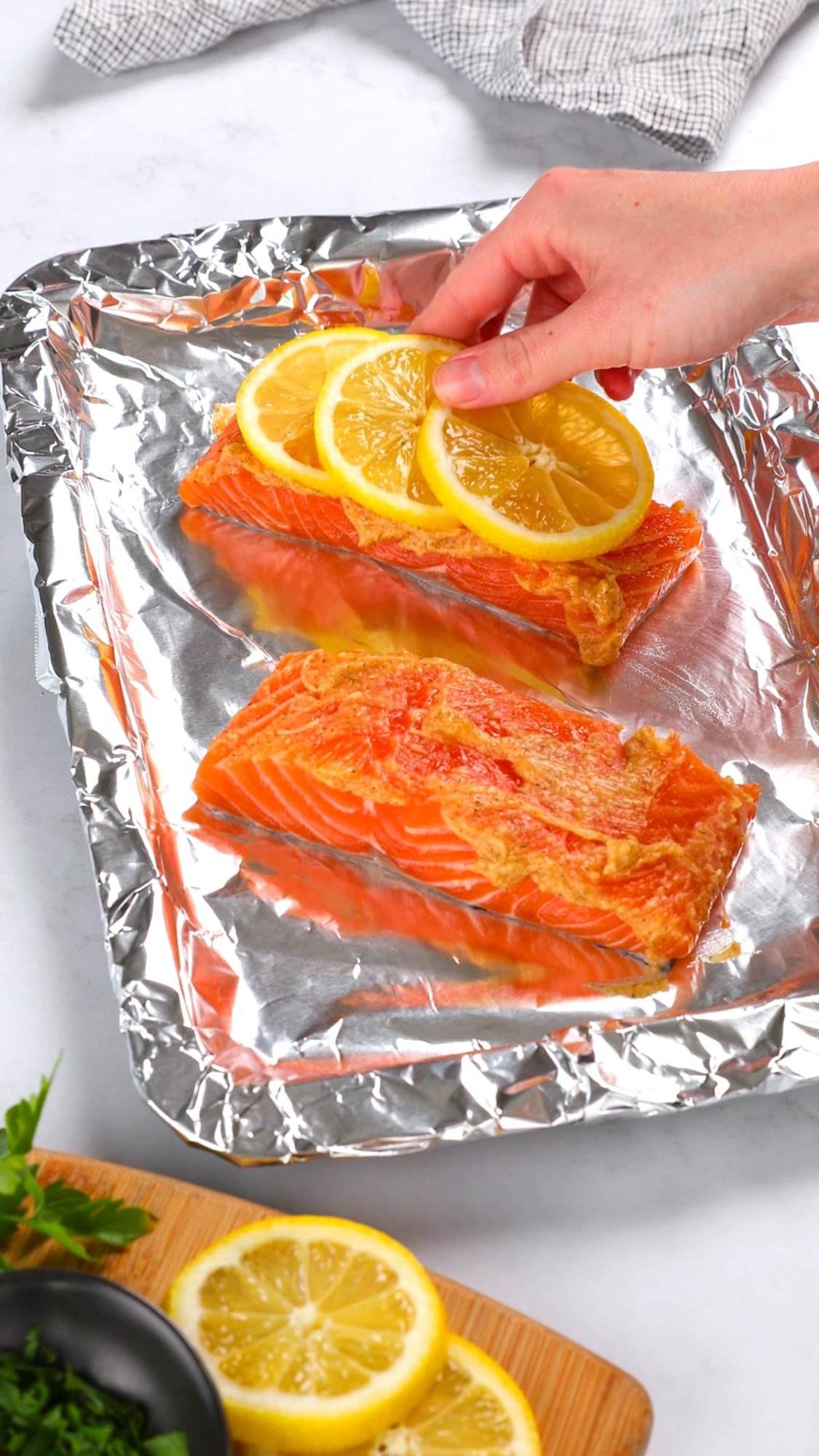 Recipe for oven baked honey garlic salmon on foil getting ready to bake.