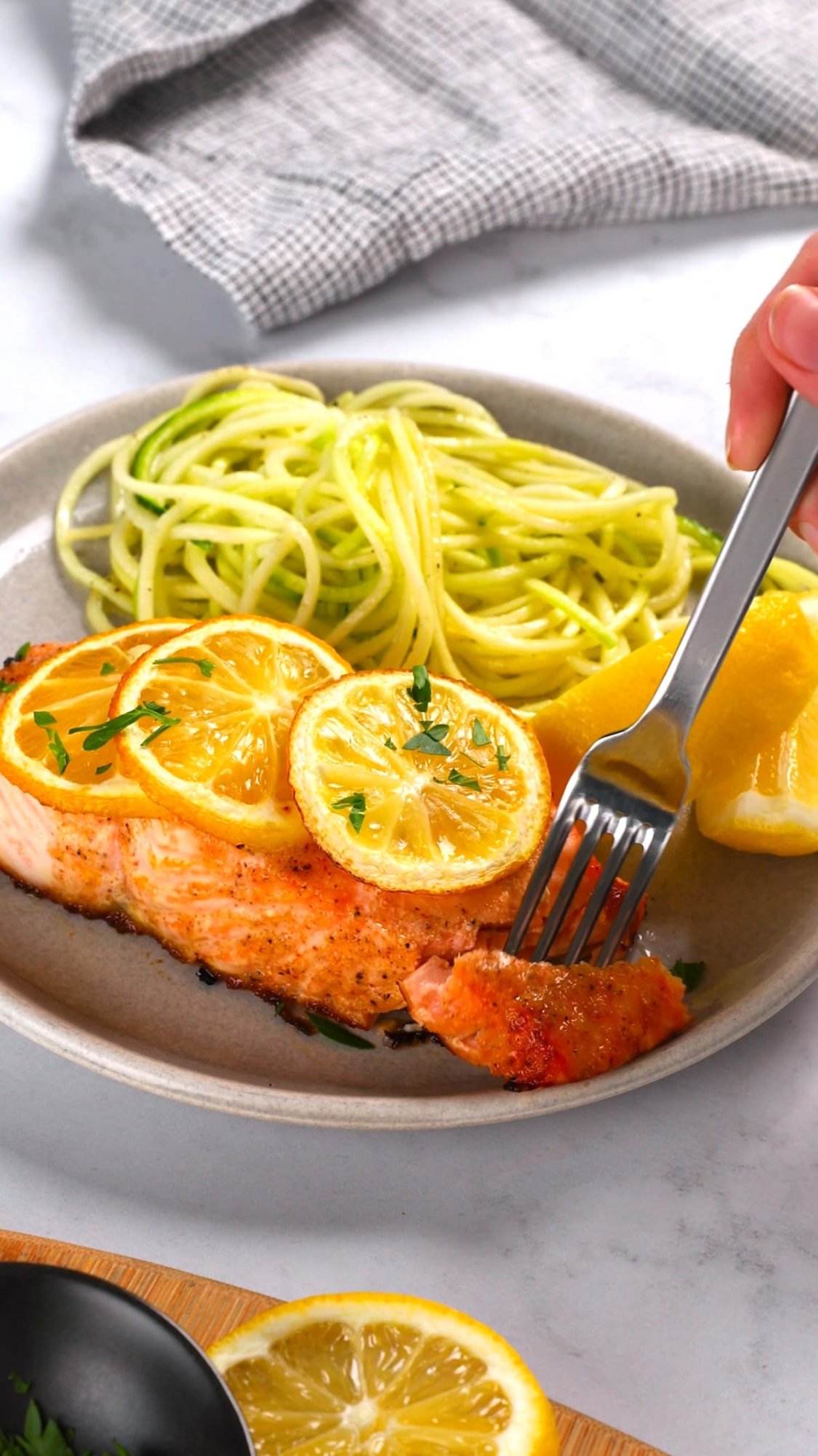 Serving honey garlic salmon filets with a side of zucchini noodles.