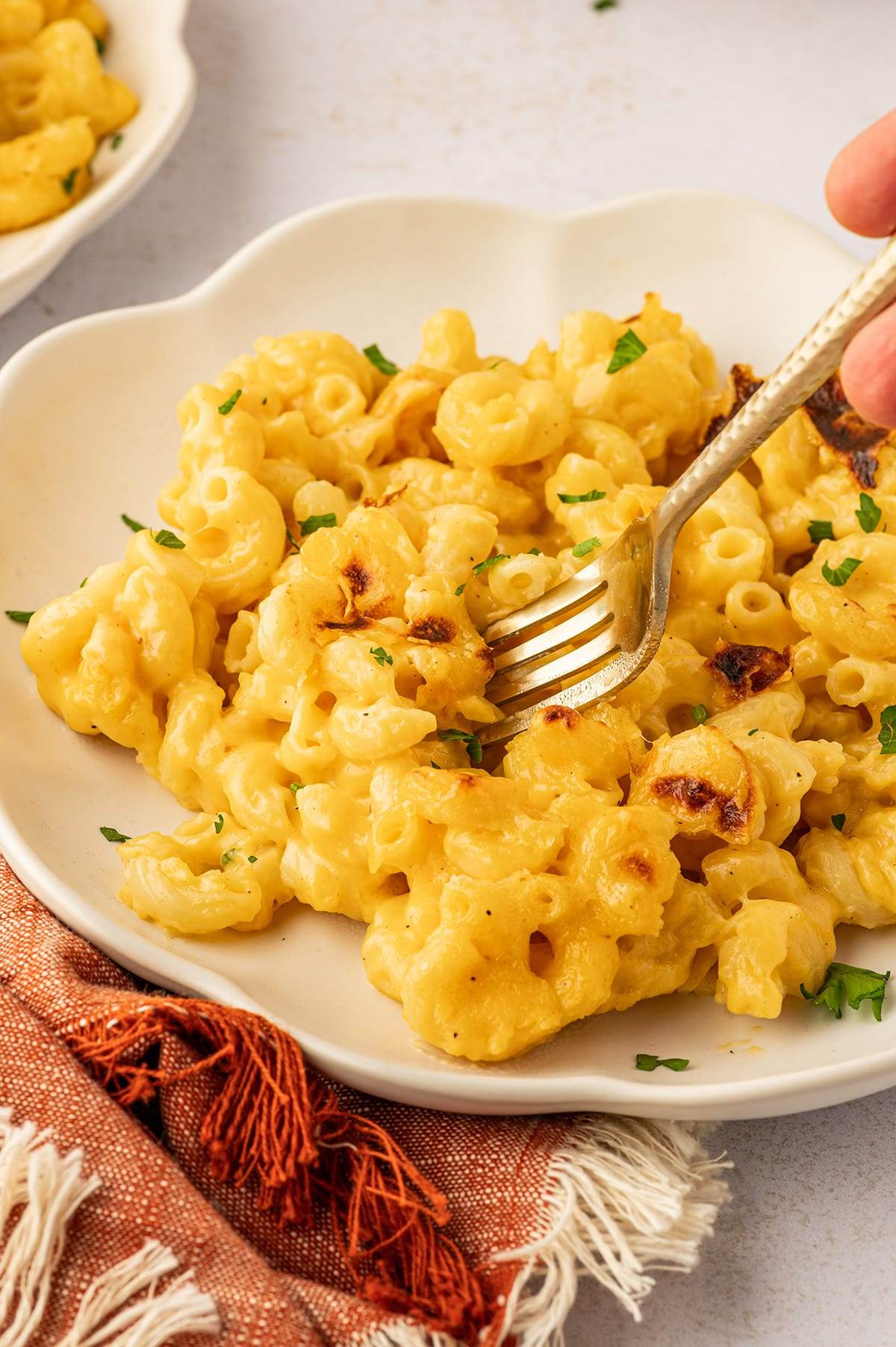 Taking a forkful of baked mac and cheese.