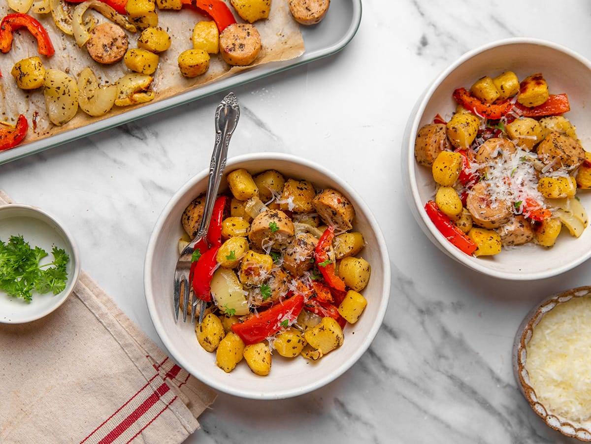Sheet Pan gnocchi with sausage and peppers served in a bowl, garnished with fresh parsley.