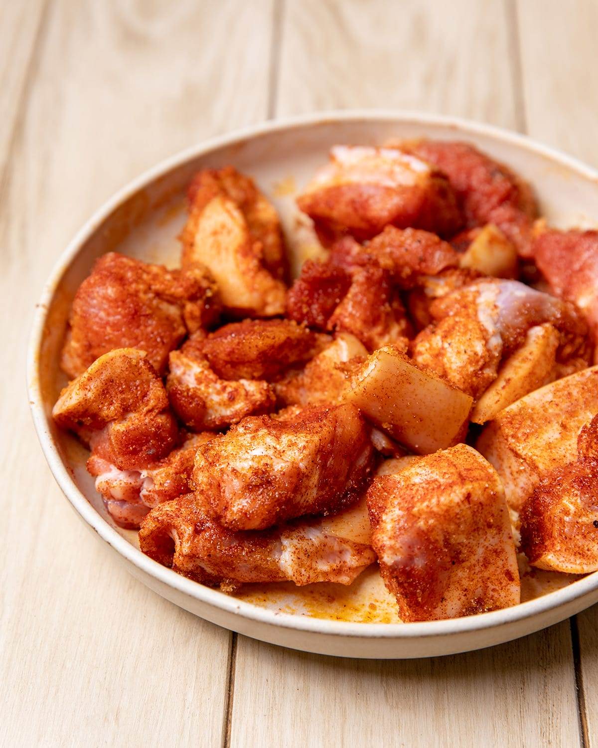 Seasoning pork belly bites to cook in an air fryer.
