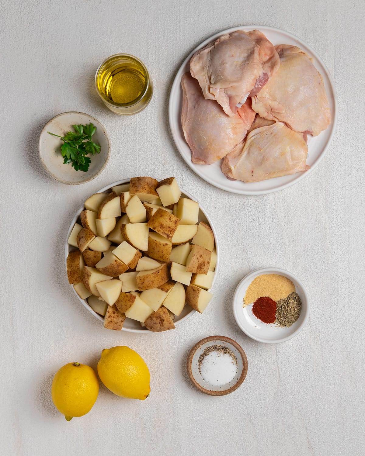 All the ingredients for making sheet pan lemon chicken and potatoes.