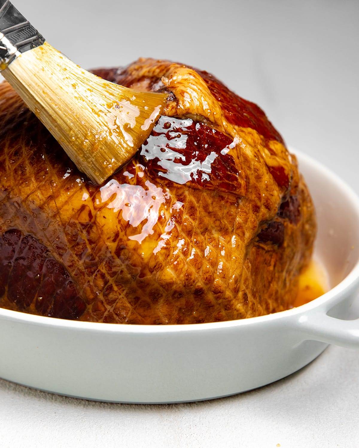 Applying a maple and brown sugar glaze to our baked ham.