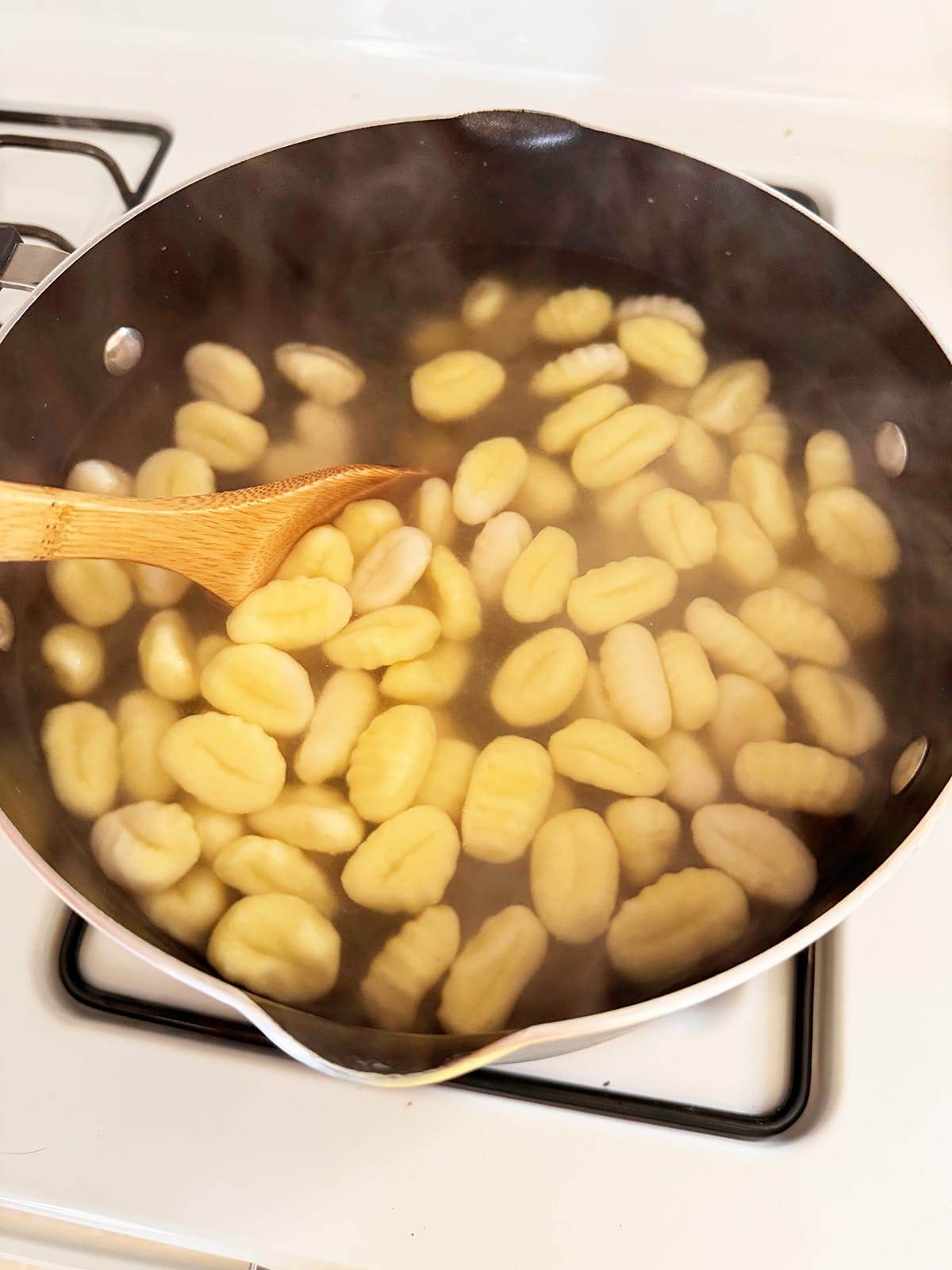 Gnocchi boiling in a pot of water.