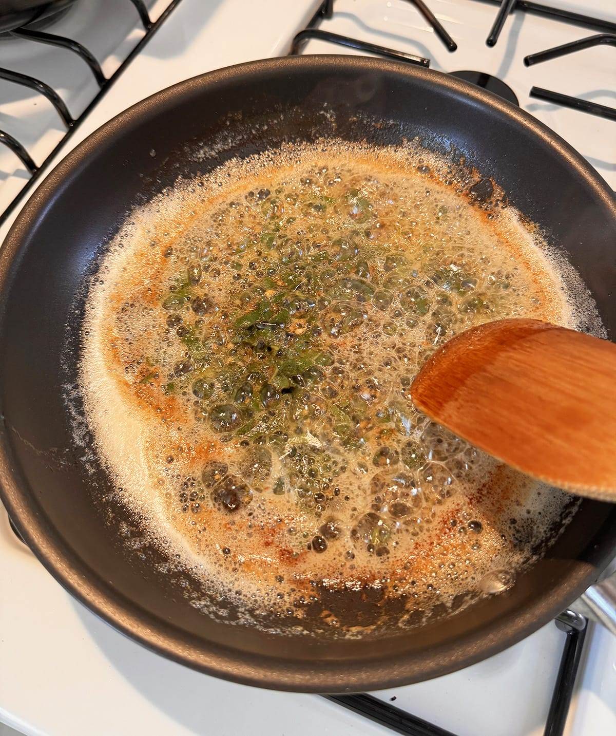 Browning butter in a saucepan with garlic and fresh sage.
