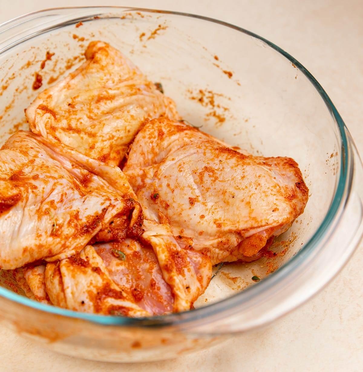 Seasoned chicken thighs ready to be cooked.