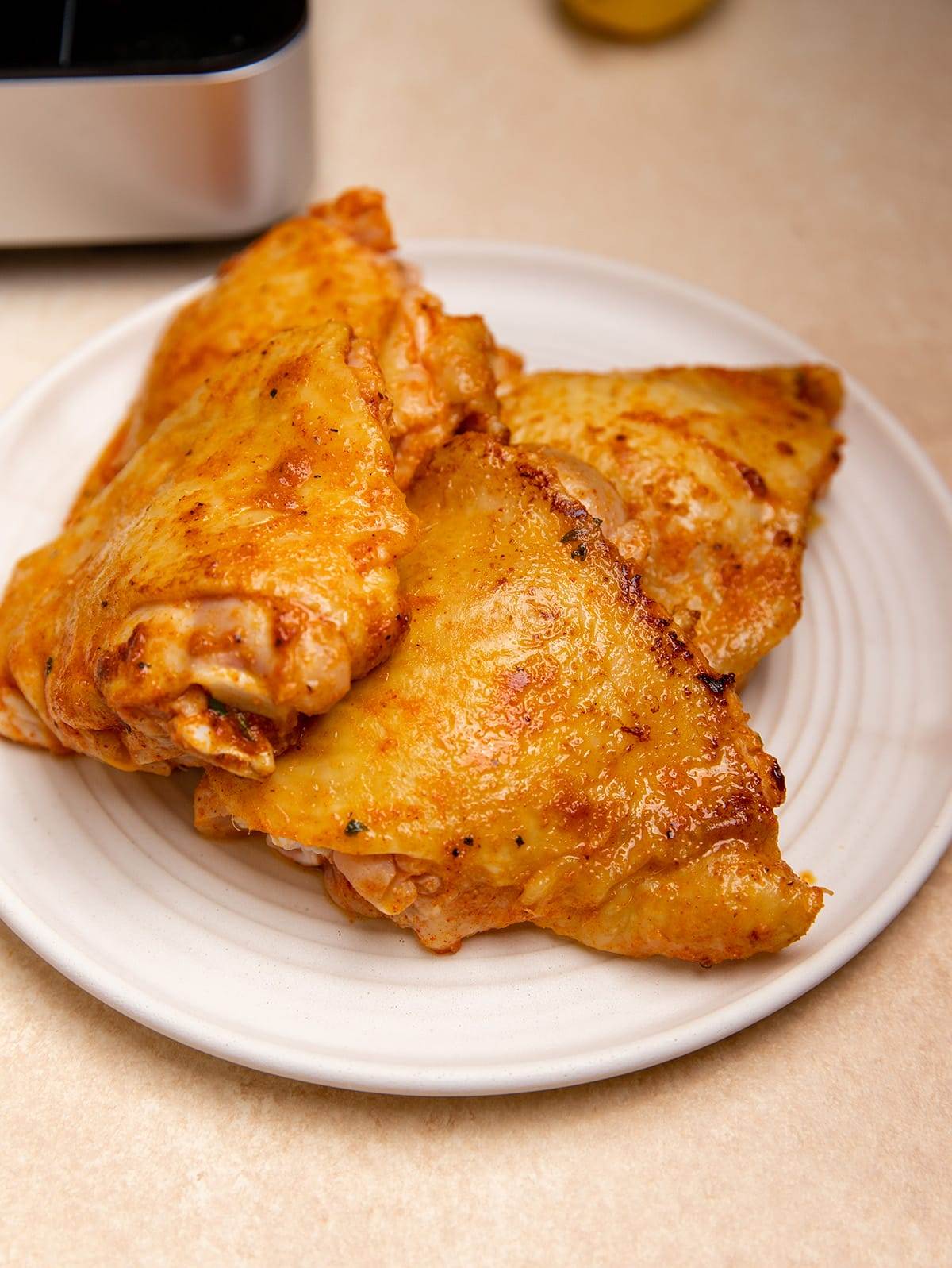 Chicken thighs that have been browned and ready to cook with brown rice.